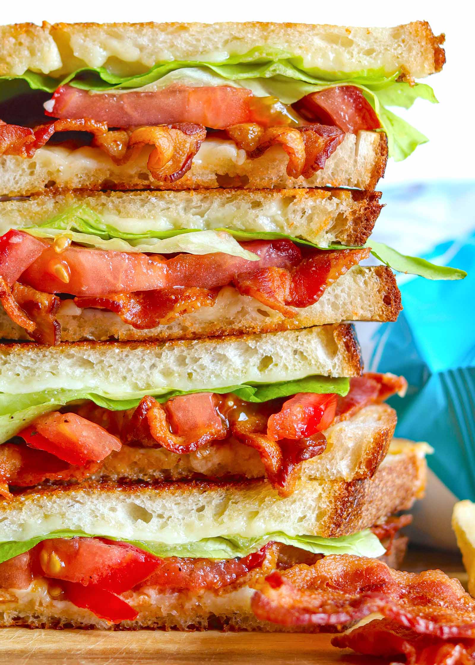 Closeup of crispy bacon, lettuce, and tomato on toasted grilled cheese bread