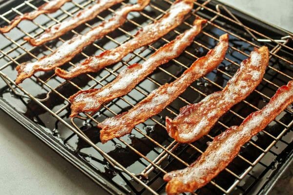 How To Cook Bacon in the Oven - browned bacon on baking sheet rack