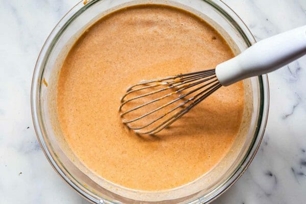 Whisking together the custard for easy homemade sweet potato pie.