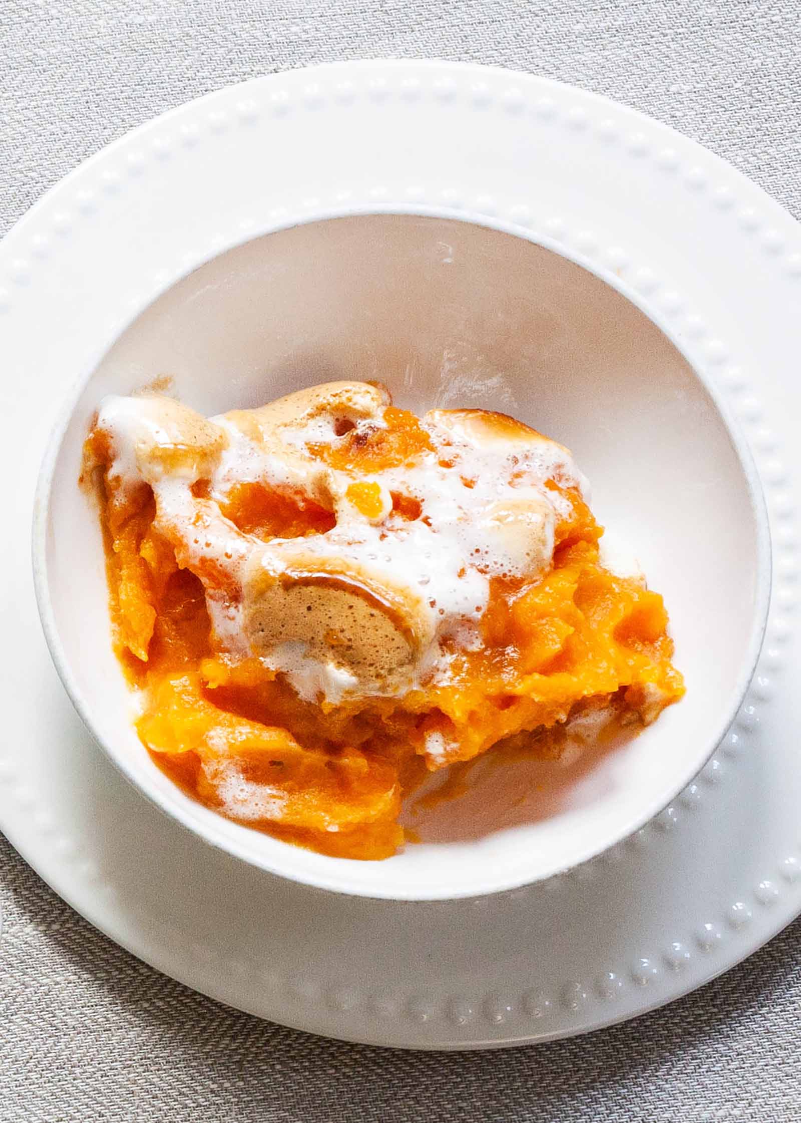 Easy Sweet Potato Casserole with Marshmallows plated in a white serving bowl