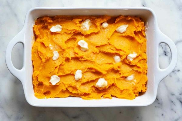 Best Sweet Potato Casserole with Marshmallows dot the casserole with butter