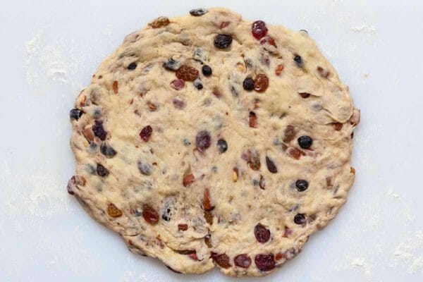 Stollen Christmas Bread dough filled with rum-soaked dried fruit and patted into a round.