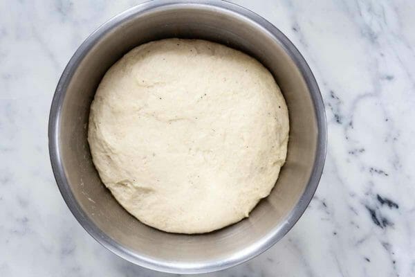 Risen Dough for Stollen in a silver mixing bowl