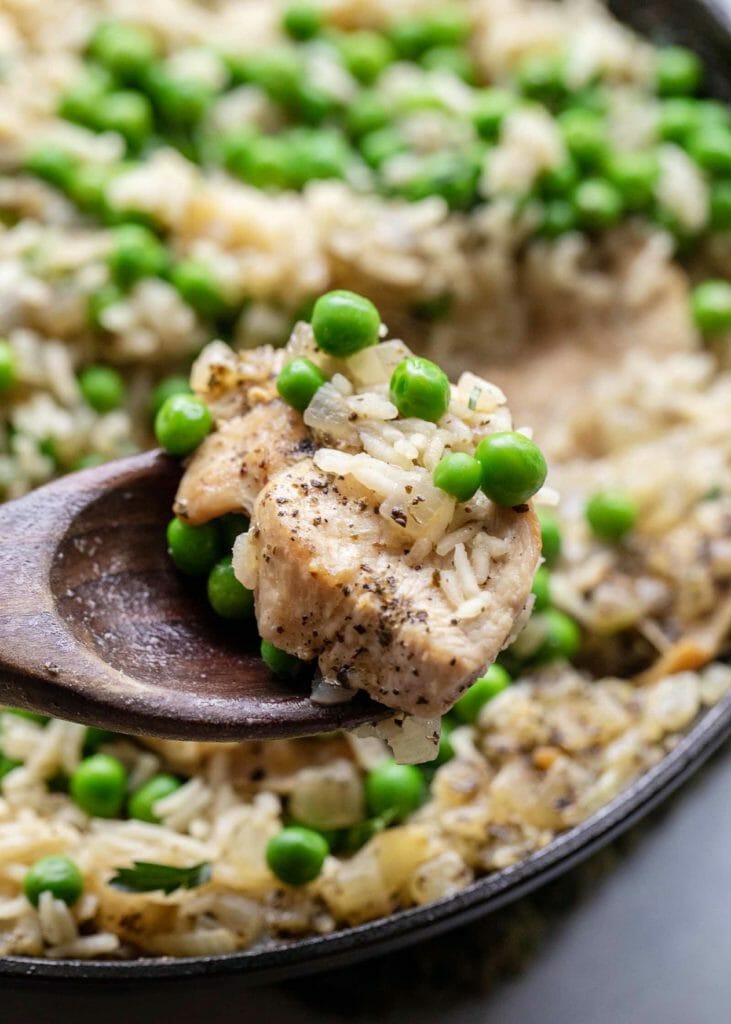 Chicken and rice on the stove with peas