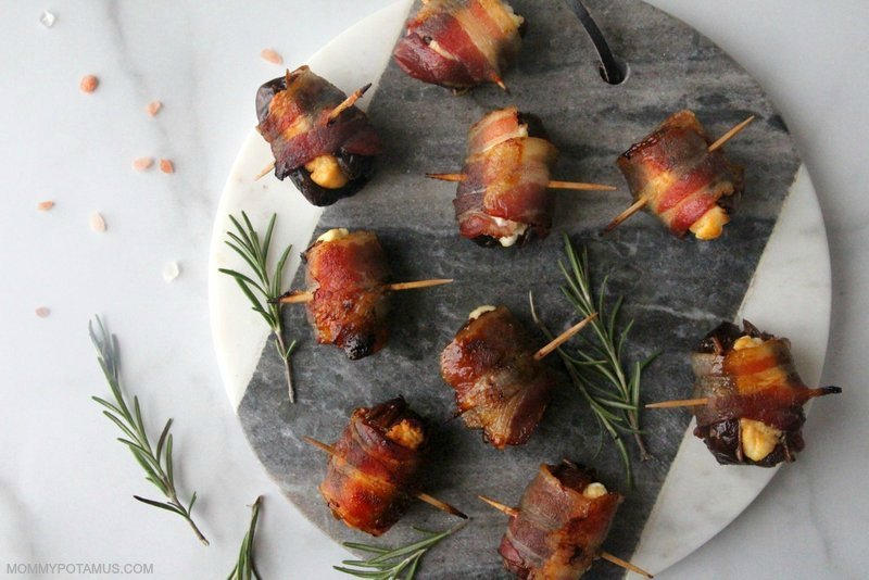 Bacon wrapped dates with goat cheese on marble cutting board