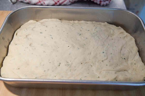 Pat the dough for focaccia bread into the pan