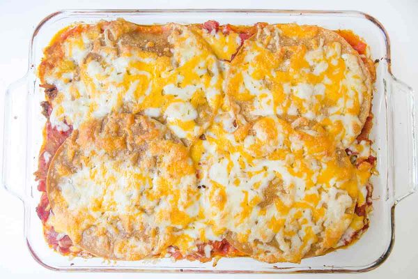 Bake the taco lasagna until the cheese is melted and the edges are bubbling