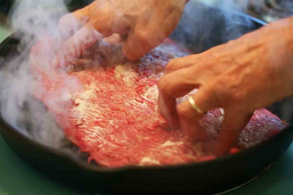 place flank steak in frying pan