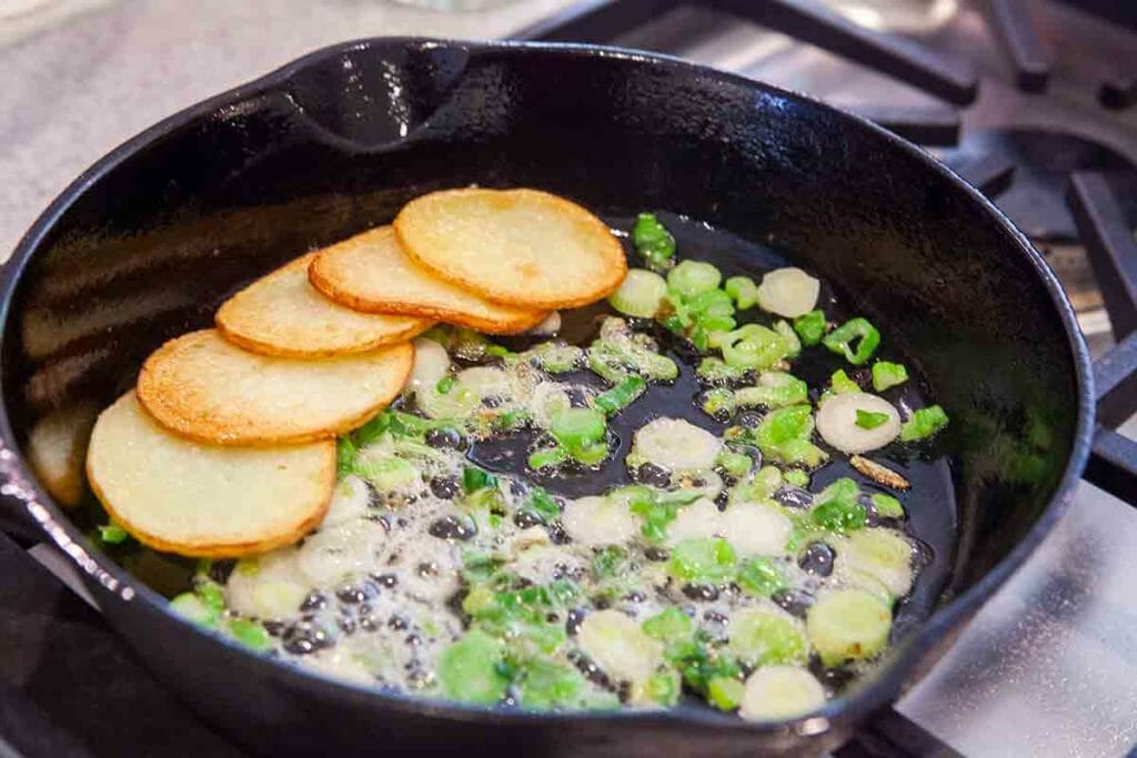 fry onions in cast iron pan for spanish tortilla