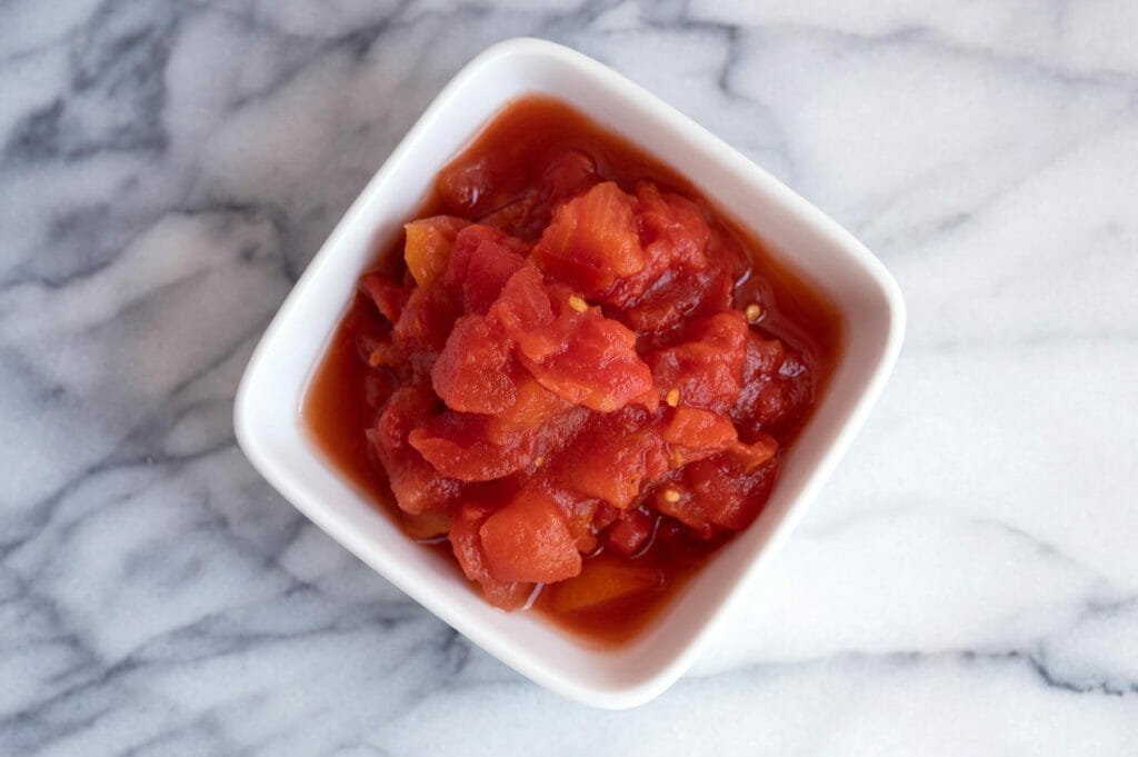 Diced tomatoes in white bowl