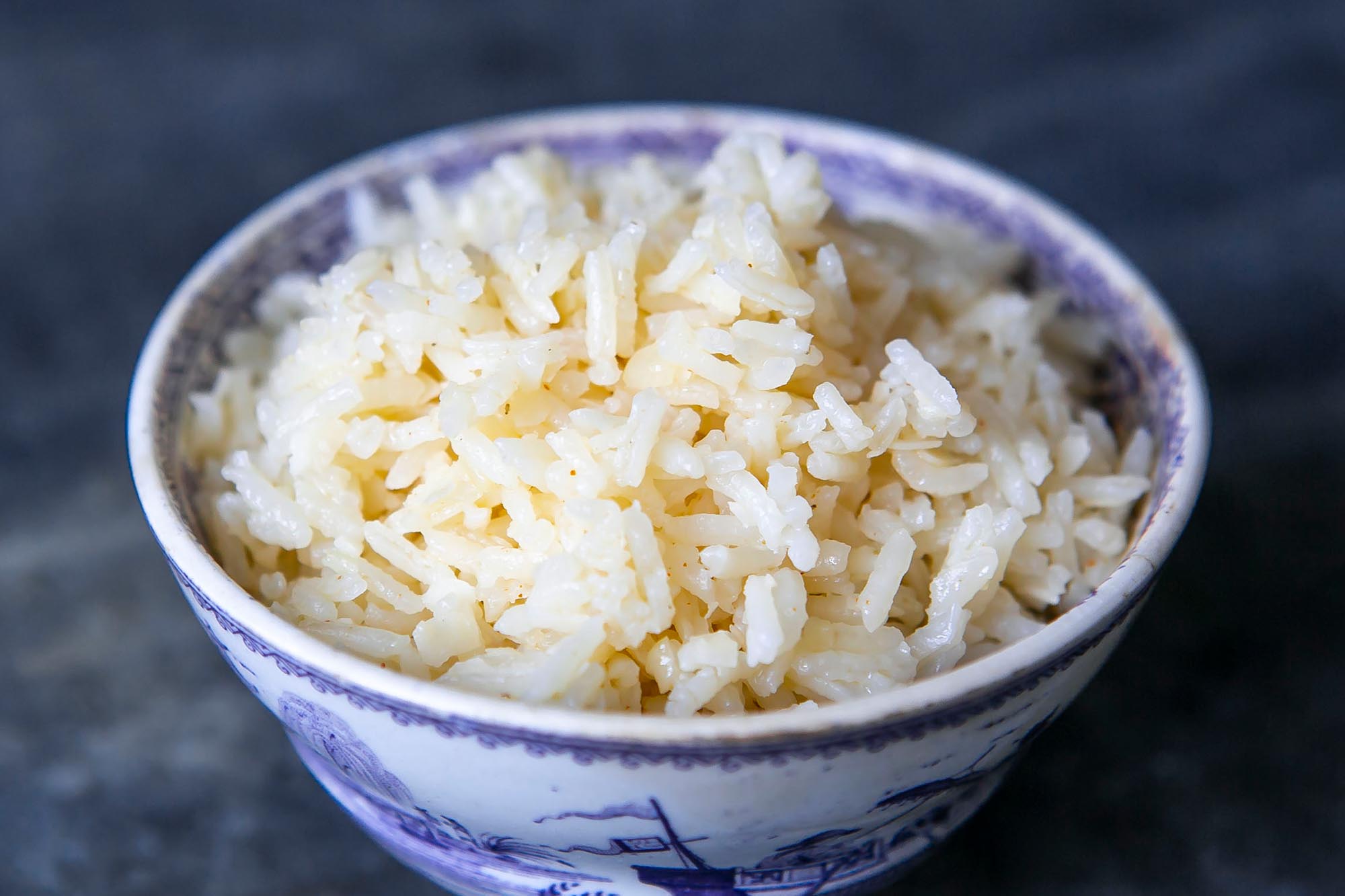 Coconut rice made with coconut, coconut water, and coconut oil in a round bowl