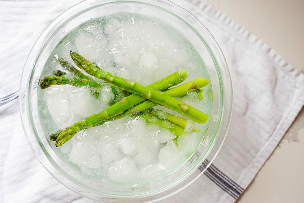 asparagus in glass bowl with ice