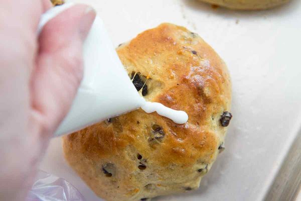 Piping the crosses onto the tops of the homemade hot cross buns