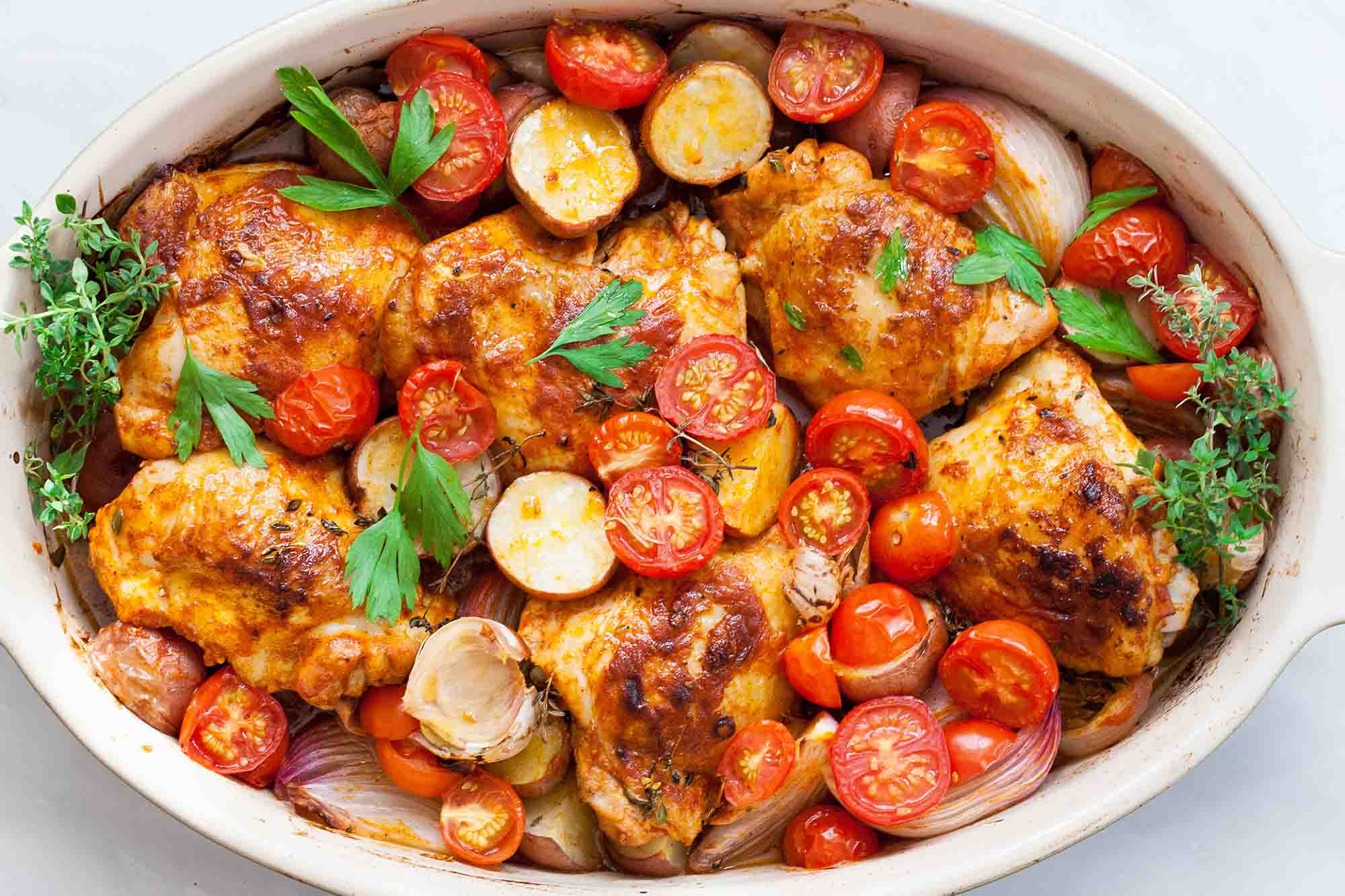 Paprika Chicken and Potatoes with Tomatoes horizontal in a baking dish