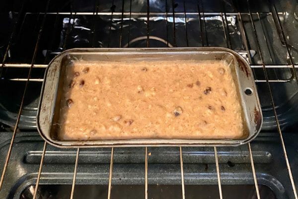 Jamaican Banana Bread batter in a loaf pan in the oven.