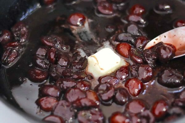 Cherries with a pat of butter and liquid to make cherry sauce for the best pork chops.