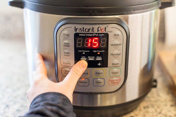 A person setting an Instant Pot for porcupine balls.