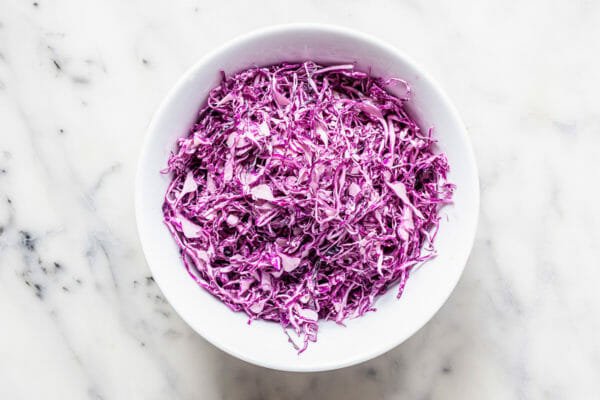 Shredded cabbage in a bowl for a fish taco recipe.
