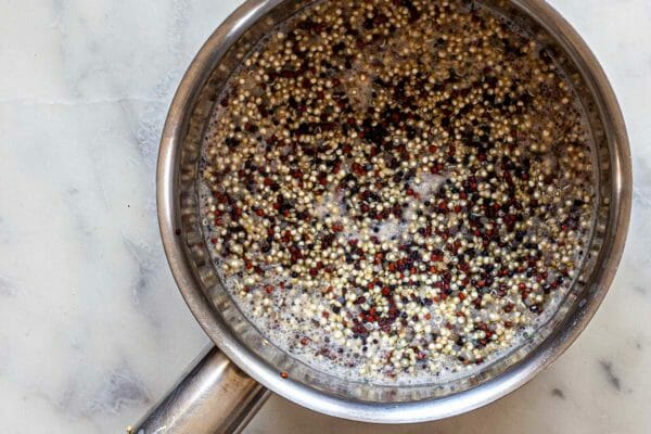 Homemade quinoa recipe in a saucepan and simmering in water.
